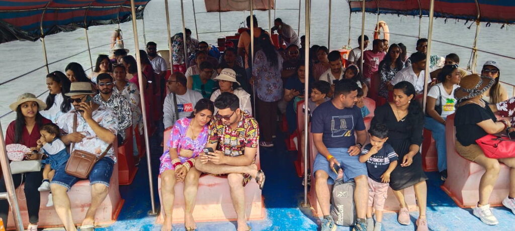 Tourists aboard a boat during a Grand Island and dolphin trip in Goa