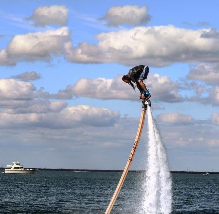 Advanced flyboarder diving during a session in Goa