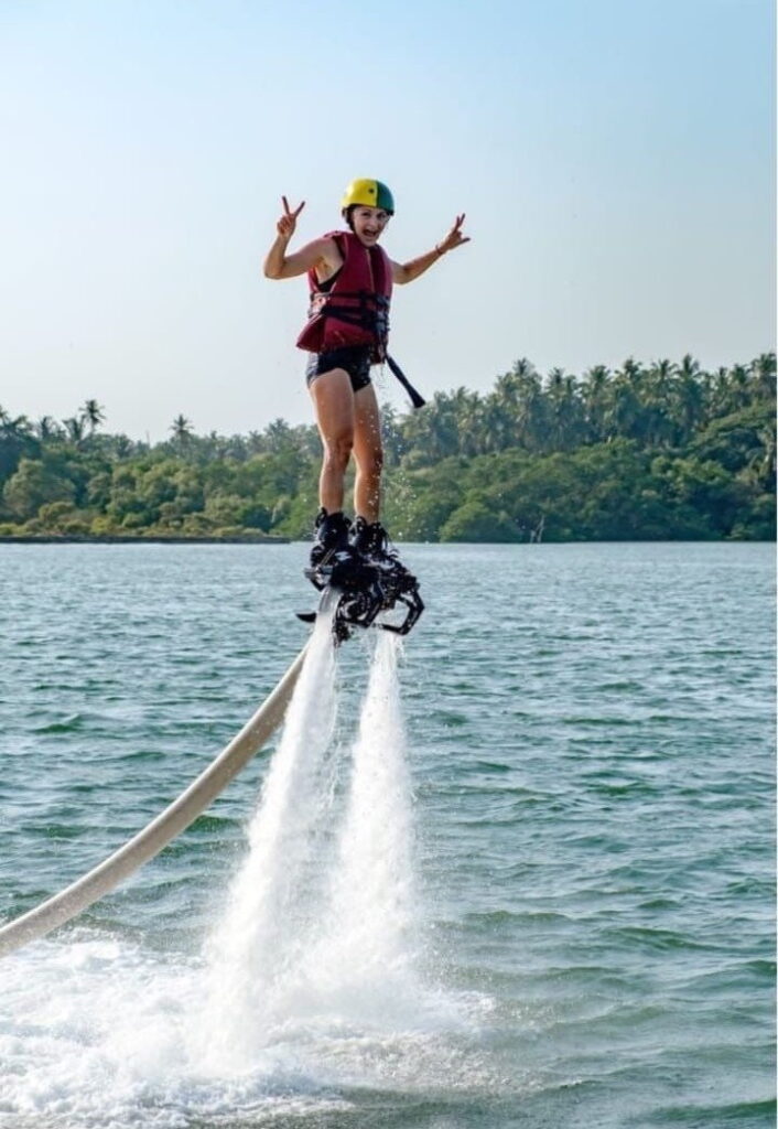 Flyboarder standing upright above the backwaters in Goa
