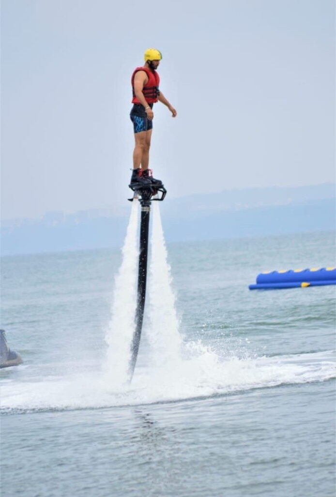 Flyboarder in full safety gear during a flyboarding session in Goa