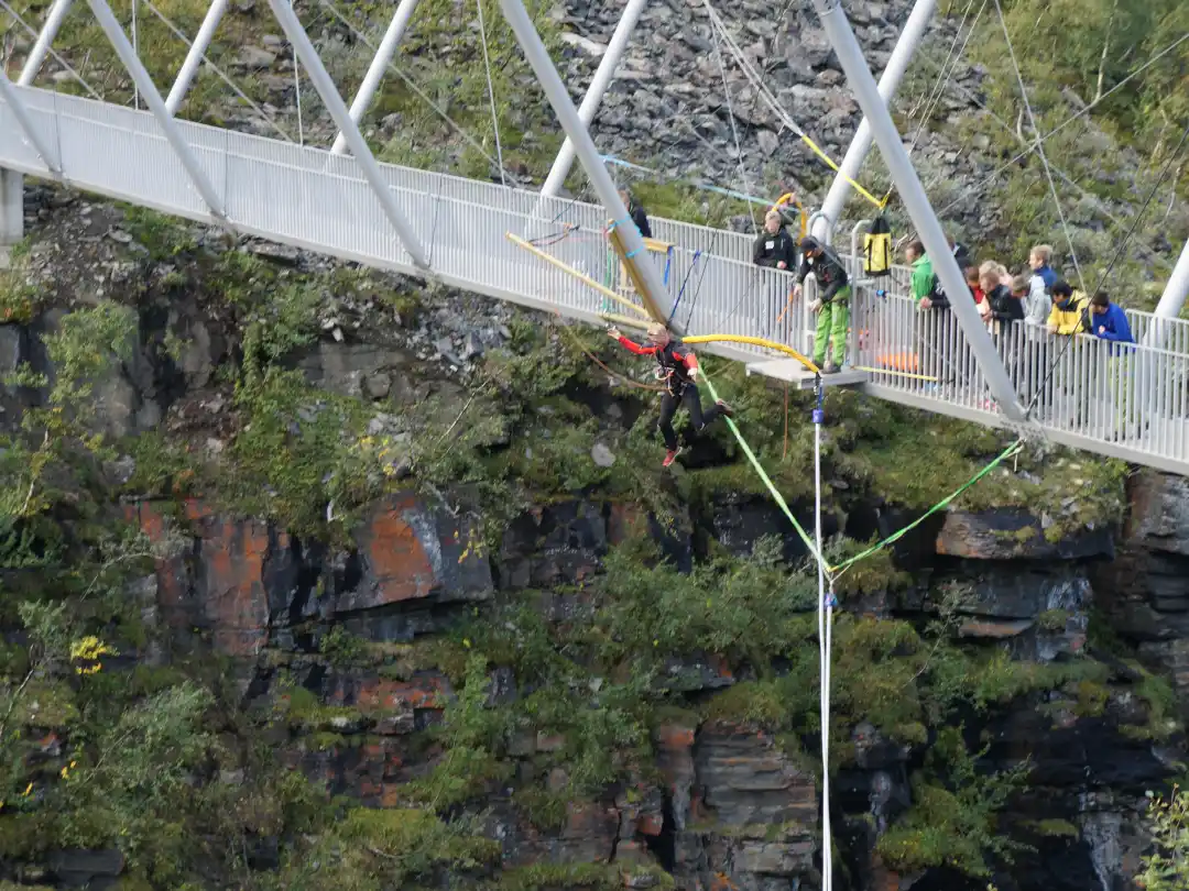Person bungee jumping in freefall from a high bridge tower