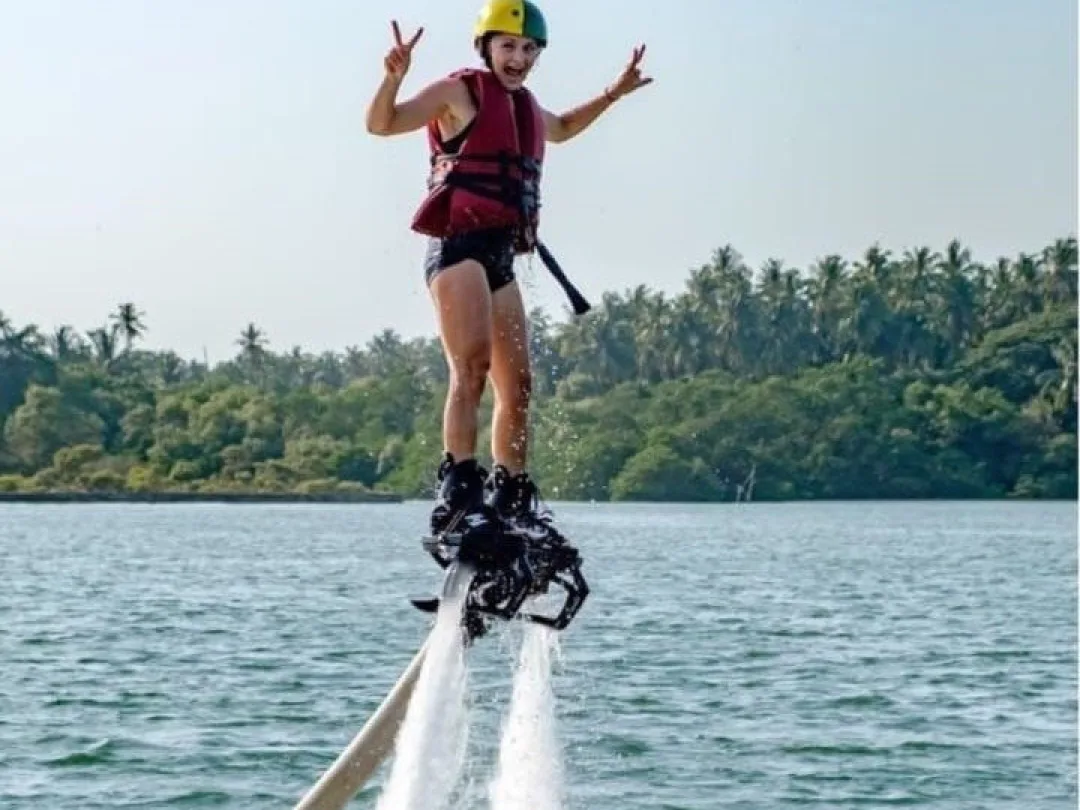 Flyboarder standing upright above the Chapora River, Goa